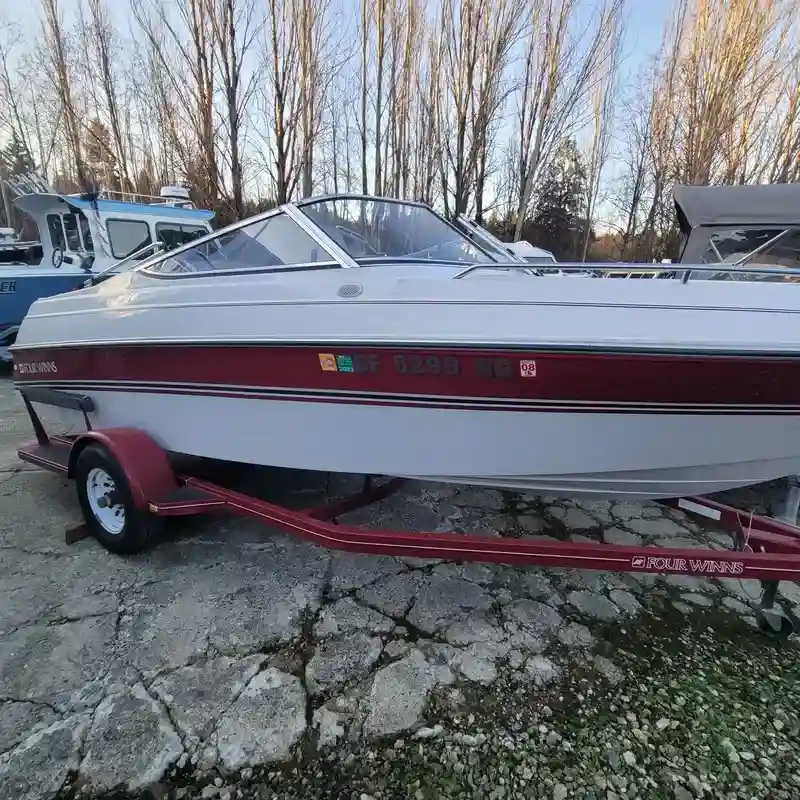 Old abandoned boat being towed for removal and disposal
